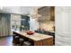 Stunning kitchen boasts marble counters, stainless hood, pendant lighting, and seating at the island at 3488 Tuxedo Nw Rd, Atlanta, GA 30305