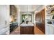 Contemporary kitchen features a large island, custom cabinets, premium appliances, and designer lighting at 3488 Tuxedo Nw Rd, Atlanta, GA 30305