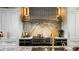 The kitchen includes marble backsplash, stainless vent hood, premium appliances, and custom cabinets at 3488 Tuxedo Nw Rd, Atlanta, GA 30305
