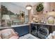 Beautifully decorated laundry room featuring blue cabinetry, elegant mural, and modern washer and dryer at 3488 Tuxedo Nw Rd, Atlanta, GA 30305