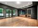 Spacious living room boasting hardwood floors, large windows, dark walls, and custom built-in cabinets at 3488 Tuxedo Nw Rd, Atlanta, GA 30305