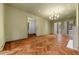 Spacious living room featuring herringbone wood floors, a modern fireplace, and open access to additional rooms at 3488 Tuxedo Nw Rd, Atlanta, GA 30305