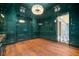 Elegant living room featuring hardwood floors, glossy walls and a modern chandelier at 3488 Tuxedo Nw Rd, Atlanta, GA 30305