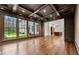Bright living room boasts coffered ceilings, hardwood floors, and grand windows offering exterior views at 3488 Tuxedo Nw Rd, Atlanta, GA 30305