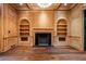 Elegant living room features wood paneling, built-in bookshelves, fireplace, and hardwood floors at 3488 Tuxedo Nw Rd, Atlanta, GA 30305