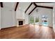 Bright living room boasts vaulted ceilings, wood beams, and a cozy fireplace at 3488 Tuxedo Nw Rd, Atlanta, GA 30305