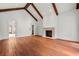 Living room features vaulted ceilings, wooden beams, and a stone fireplace at 3488 Tuxedo Nw Rd, Atlanta, GA 30305