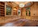 Elegant living room features wood paneling, built-in bookshelves, large windows, and hardwood floors at 3488 Tuxedo Nw Rd, Atlanta, GA 30305