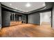 Bright living room with hardwood floors, a decorative ceiling, dark walls, and custom cabinets with a mirrored backsplash at 3488 Tuxedo Nw Rd, Atlanta, GA 30305
