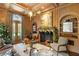 Cozy living room featuring a fireplace decorated for the holidays, wood paneling, and built-in bookshelves at 3488 Tuxedo Nw Rd, Atlanta, GA 30305