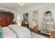 Primary bedroom featuring an ornate chandelier, a large bed, and an attached bath and hallway at 3488 Tuxedo Nw Rd, Atlanta, GA 30305