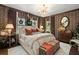 Elegant bedroom with a decorative chandelier, warm lighting, and designer wallpaper at 3488 Tuxedo Nw Rd, Atlanta, GA 30305