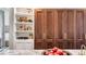 Pantry boasts custom storage, shelving, wooden doors, and easy access to the kitchen at 3488 Tuxedo Nw Rd, Atlanta, GA 30305