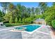 Beautiful backyard pool area with a hot tub, pool house, and lush landscaping at 3488 Tuxedo Nw Rd, Atlanta, GA 30305