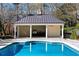 Inviting backyard pool featuring an outdoor kitchen, perfect for entertaining and enjoying the outdoors at 3488 Tuxedo Nw Rd, Atlanta, GA 30305