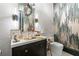Chic powder room features marble walls, unique tile, and a gold-tone sink at 3488 Tuxedo Nw Rd, Atlanta, GA 30305