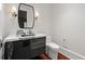 Sleek powder room with modern vanity, marble countertop, and dark wood floors at 3488 Tuxedo Nw Rd, Atlanta, GA 30305