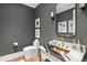 Modern powder room with gray wallpaper, a unique marble countertop, and stylish fixtures at 3488 Tuxedo Nw Rd, Atlanta, GA 30305