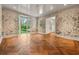 Bright room featuring decorative wallpaper, herringbone hardwood floors, and large windows with a backyard view at 3488 Tuxedo Nw Rd, Atlanta, GA 30305