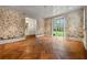 Bright room featuring decorative wallpaper, herringbone hardwood floors, and large windows with a backyard view at 3488 Tuxedo Nw Rd, Atlanta, GA 30305