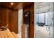 An interior view of a wood sauna, showcasing a stylish heater, seating, and view into adjoining marble bathroom at 3488 Tuxedo Nw Rd, Atlanta, GA 30305