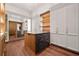 Beautiful walk-in closet featuring mirrored walls, hardwood floors, built-in storage, and center island at 3488 Tuxedo Nw Rd, Atlanta, GA 30305