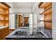 Bright walk-in closet featuring a large island with a stone countertop and custom wooden cabinetry at 3488 Tuxedo Nw Rd, Atlanta, GA 30305