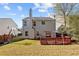 House's rear view, showcasing a deck, fence, and grassy yard at 1241 Matt Moore Ct, Lithia Springs, GA 30122