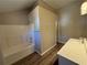 Bathroom with tub, shower, and updated vanity at 7069 Ravenwood Ln, Lithonia, GA 30038