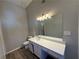Bathroom with vanity, quartz countertop, and large mirror at 7069 Ravenwood Ln, Lithonia, GA 30038