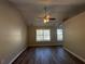 Well-lit bedroom with hardwood floors and neutral walls at 7069 Ravenwood Ln, Lithonia, GA 30038