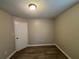 Small bedroom with hardwood floors and neutral walls at 7069 Ravenwood Ln, Lithonia, GA 30038