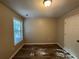 Bright bedroom with wood-look flooring and a large window at 7069 Ravenwood Ln, Lithonia, GA 30038