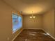 Empty dining room with hardwood floors and large window at 7069 Ravenwood Ln, Lithonia, GA 30038