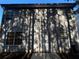 Gray sided home with a white door and several windows at 7069 Ravenwood Ln, Lithonia, GA 30038