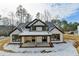 White two-story farmhouse with covered back porch, surrounded by trees at 3609 Centerville Rosebud Rd, Snellville, GA 30039