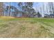 Large backyard with a grassy area and wooded backdrop at 3609 Centerville Rosebud Rd, Snellville, GA 30039