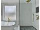 Bathroom with a soaking tub and a walk-in shower with modern fixtures at 3609 Centerville Rosebud Rd, Snellville, GA 30039