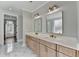 Bathroom with double vanity, marble floors, and access to a walk-in closet at 3609 Centerville Rosebud Rd, Snellville, GA 30039