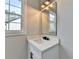 Modern bathroom with a white vanity, black matte fixtures, and a framed mirror at 3609 Centerville Rosebud Rd, Snellville, GA 30039