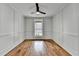 Spacious bedroom with hardwood floors, wainscoting, and a ceiling fan at 3609 Centerville Rosebud Rd, Snellville, GA 30039