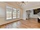 Bright dining room boasts hardwood floors, large windows, and a stylish chandelier at 3609 Centerville Rosebud Rd, Snellville, GA 30039