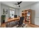Home office with built-in shelving, hardwood floors, and a large window at 3609 Centerville Rosebud Rd, Snellville, GA 30039