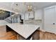 Open kitchen with large island, white cabinets and gold fixtures at 3609 Centerville Rosebud Rd, Snellville, GA 30039