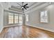 Main bedroom with hardwood floors, tray ceiling, and large windows at 3609 Centerville Rosebud Rd, Snellville, GA 30039