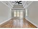 Main bedroom with hardwood floors, tray ceiling, and large windows at 3609 Centerville Rosebud Rd, Snellville, GA 30039