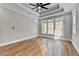 Main bedroom with hardwood floors, tray ceiling, and large windows at 3609 Centerville Rosebud Rd, Snellville, GA 30039