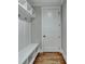 White built-in bench with storage and hooks for coats at 3609 Centerville Rosebud Rd, Snellville, GA 30039