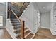 Elegant staircase with dark wood treads and black metal railing at 3609 Centerville Rosebud Rd, Snellville, GA 30039