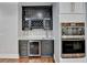 Stylish wet bar with dark cabinetry, wine rack, and quartz countertop at 3609 Centerville Rosebud Rd, Snellville, GA 30039
